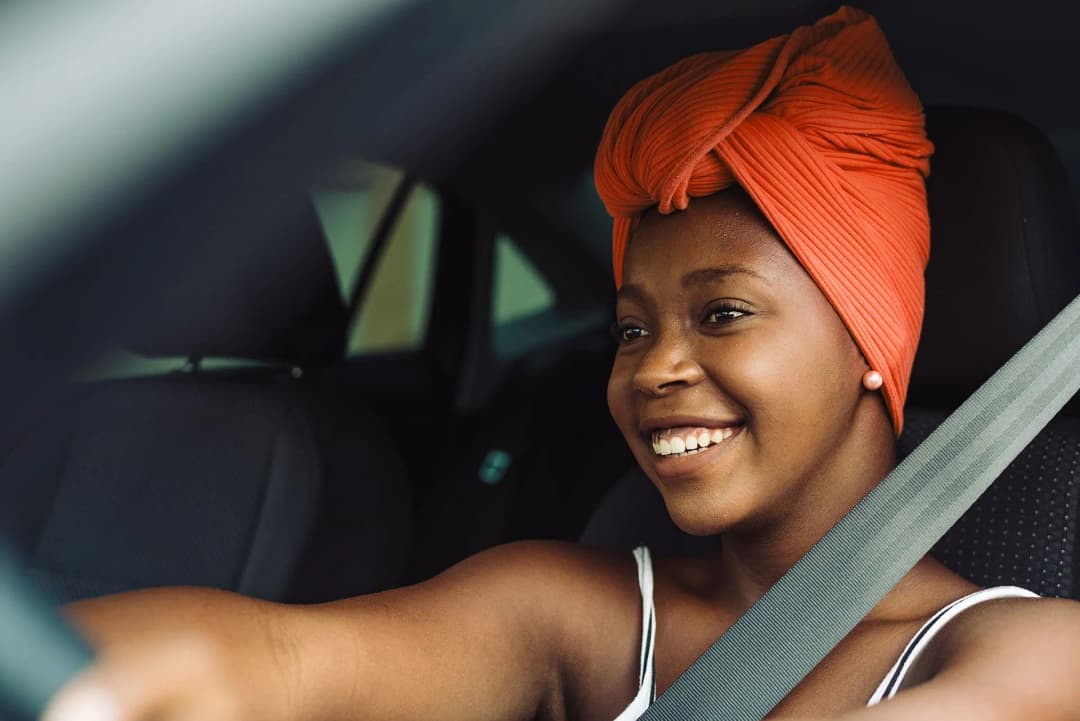 A Detour driver smiling behind the wheel